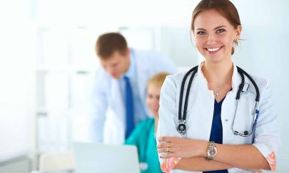 Attractive female doctor in front of medical group